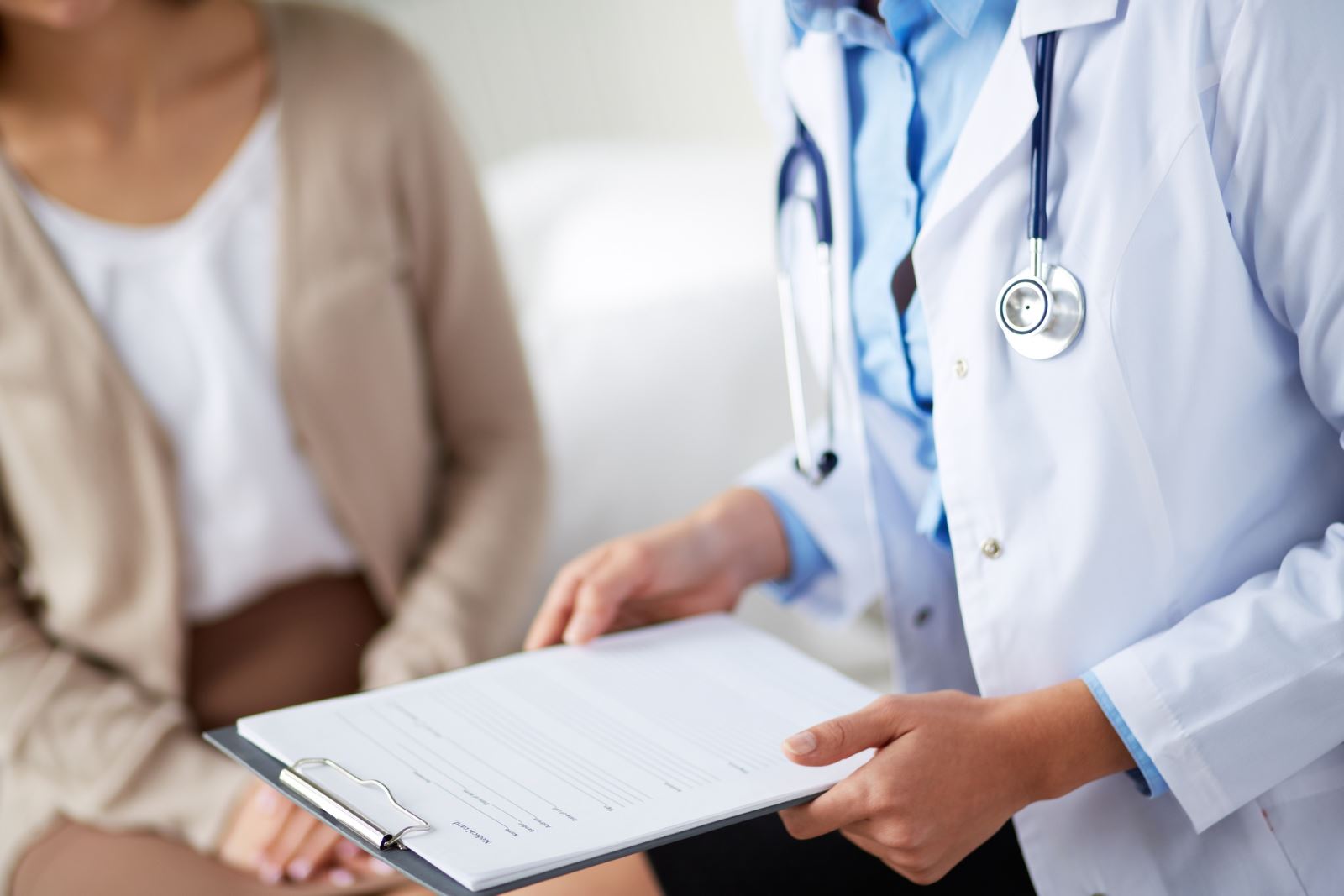 Doctor holding a clipboard seeing a patient