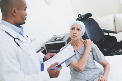 The doctor interrogates the woman. A woman undergoes rehabilitation after cancer treatment.