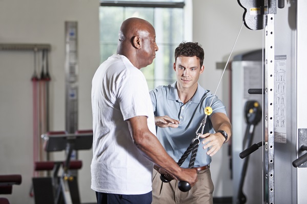 Physical therapist helping African American patient