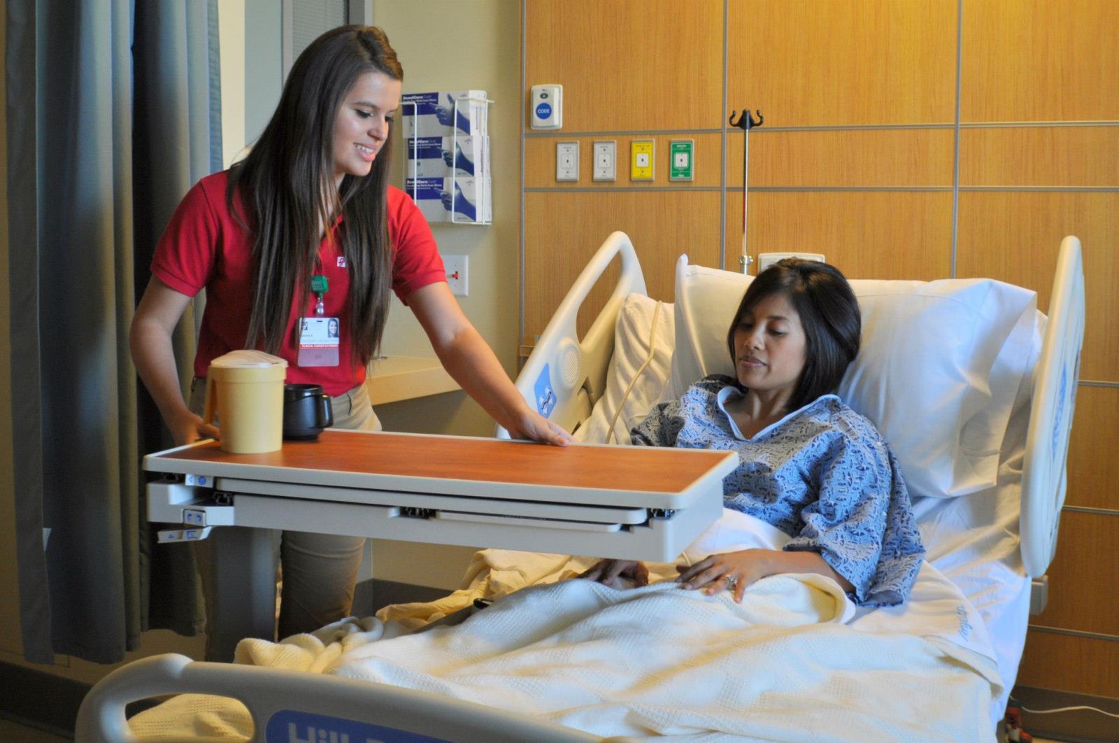 Nurse helping patient in a room