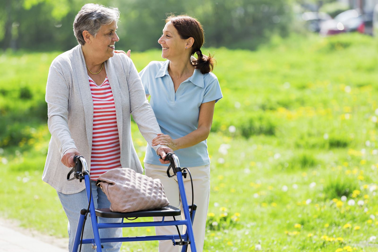 Female family member helping Older member in a walker