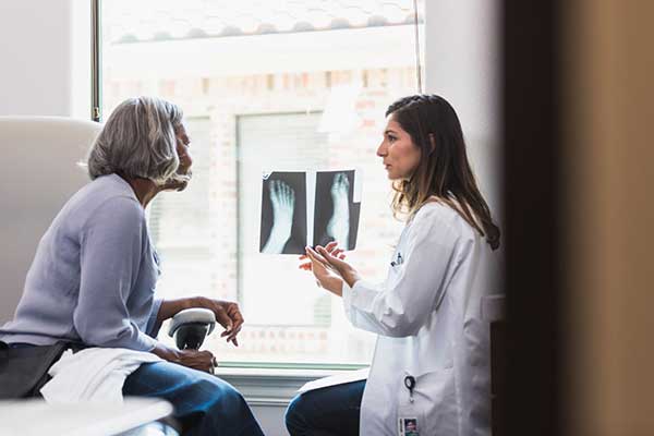 Doctor Showing Patient X-ray of foot results