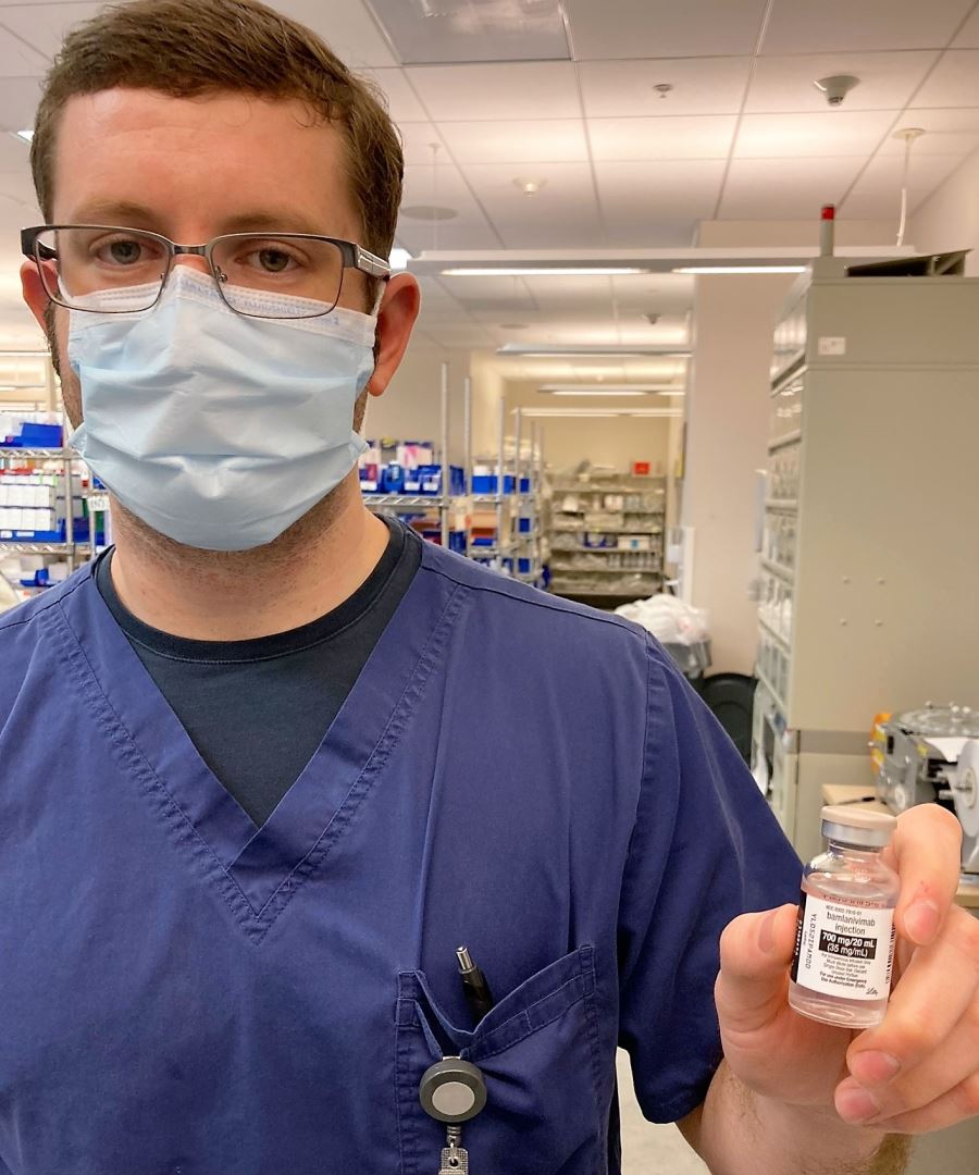Man Holding A Vial of Monoclonal AntiBody