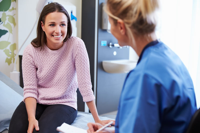 Female physician speaking to a woman